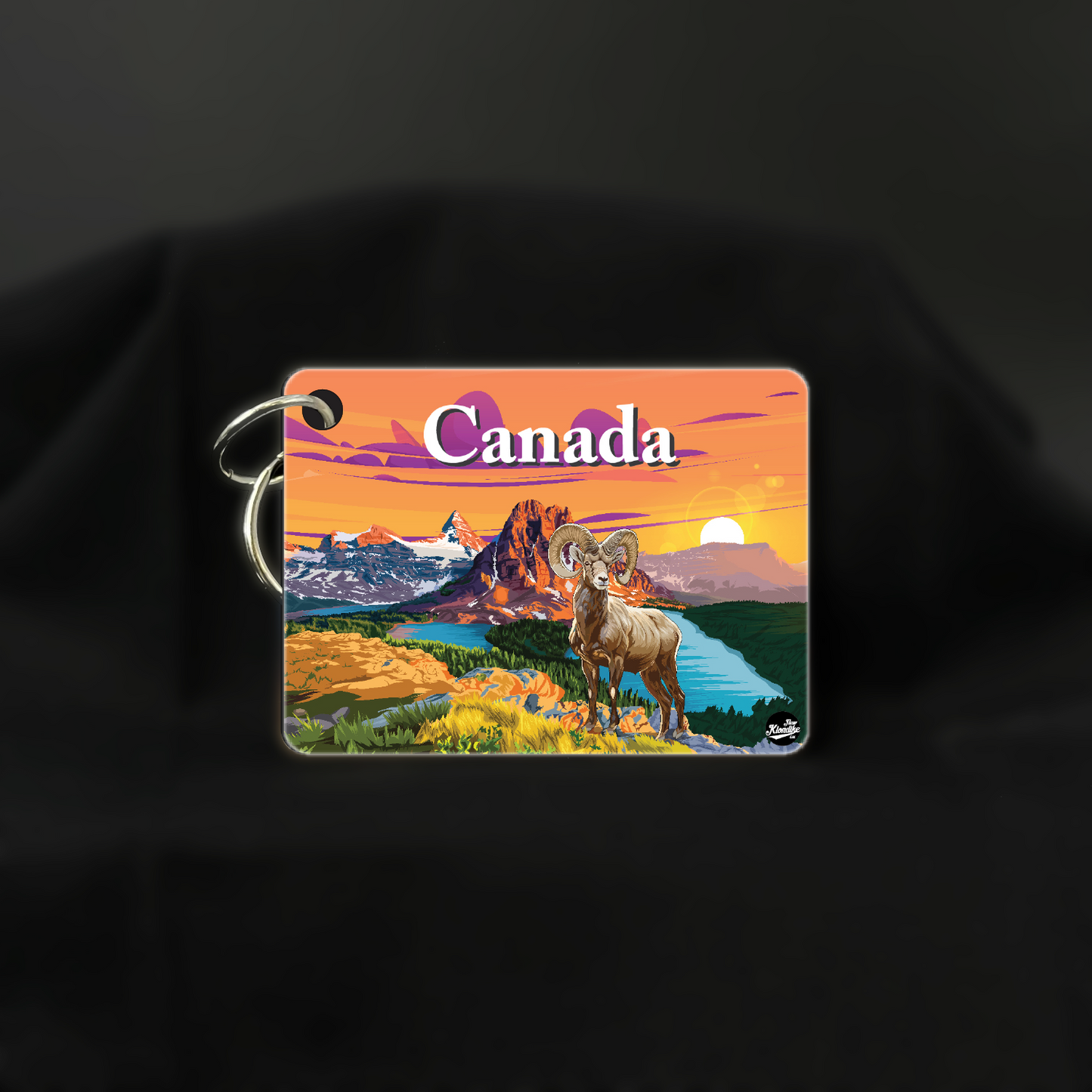 Art key chain featuring a sunrise scene of the Canadian Rockies with a big horn mountain, by New Klondike Arts and Media.