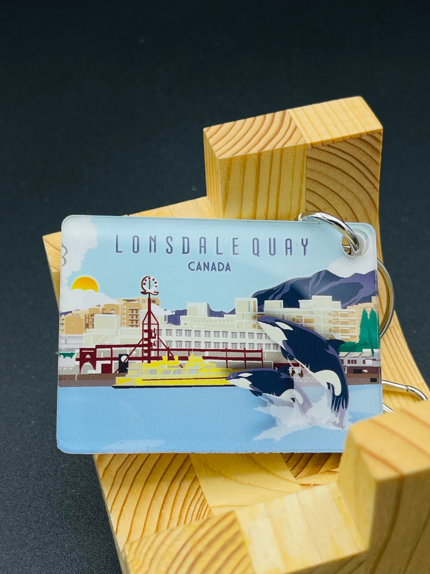 Key chain featuring Lonsdale Quay and orca whale design by New Klondike Arts, showcasing Vancouver, Canada scenery.