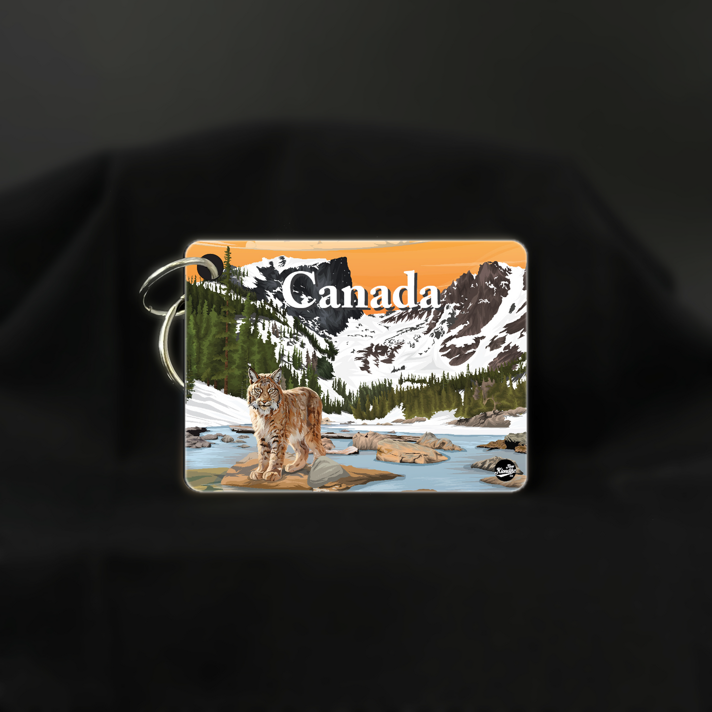 Art key chain featuring a lynx with a sunrise scene from the Canadian Rockies, by New Klondike Arts and Media.