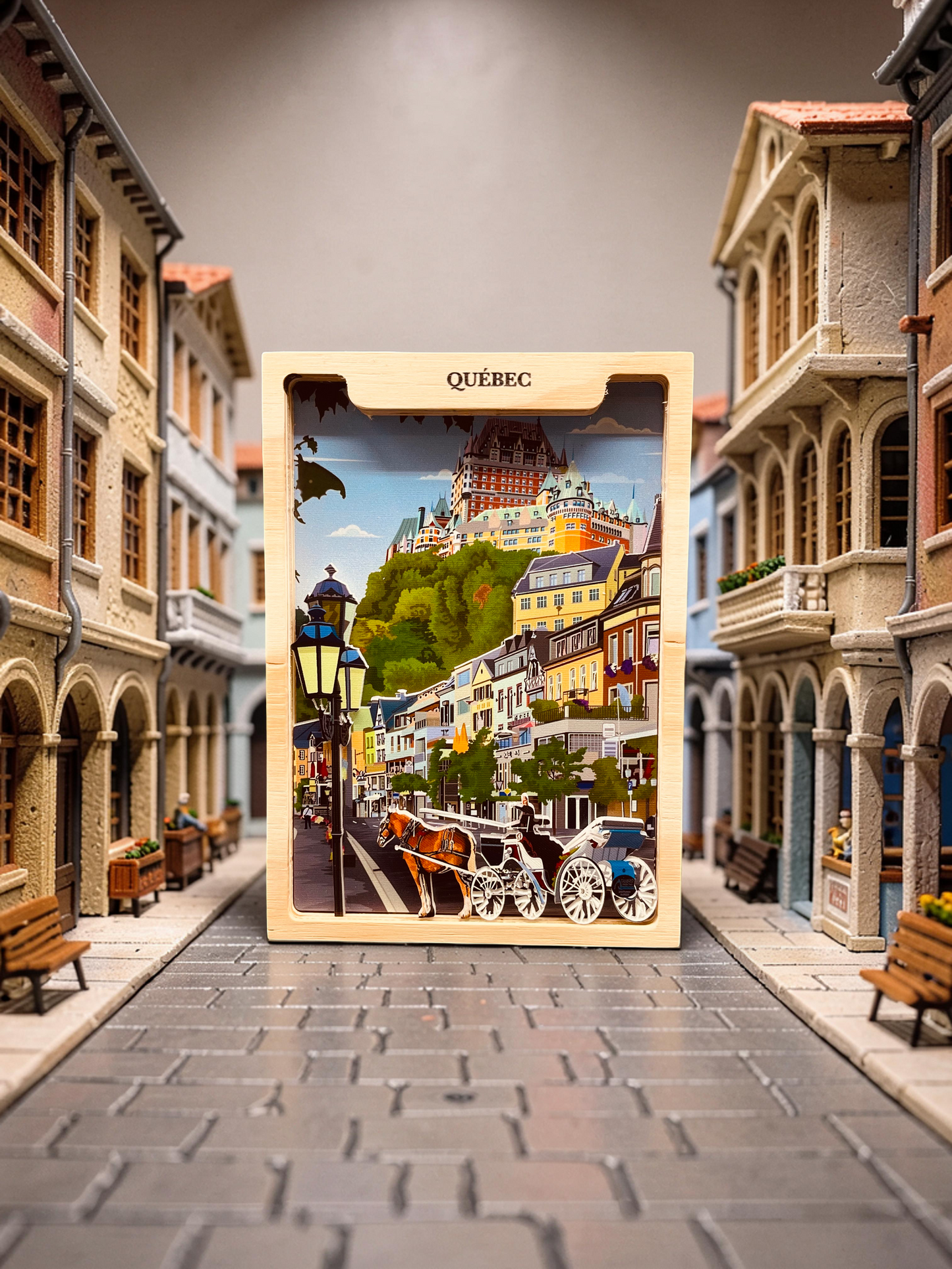 Handmade shadow box featuring Old Quebec City scene by New Klondike Arts and Media, with detailed miniature architecture and scenic background.